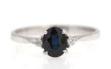 SOLD. A sapphire and diamond ring set with an oval-cut sapphire flanked by two brilliant-cut...