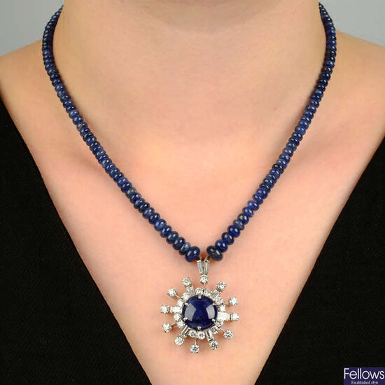 A sapphire cabochon and vari-cut diamond cluster pendant, on sapphire bead necklace.