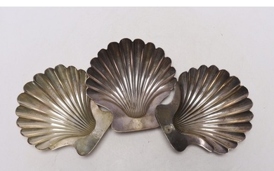A set of three George III silver butter shells, each with en...