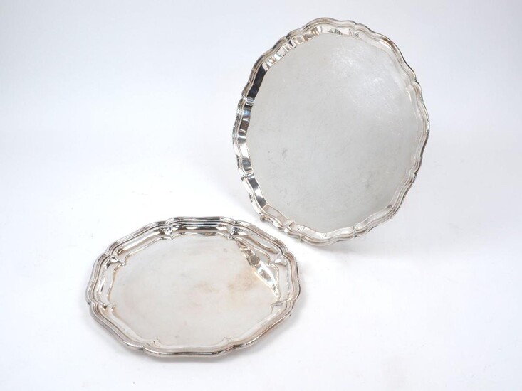 A shaped silver tray, Birmingham, 1945, Charles S Green & Co., with pie crust border, 36cm dia., together with a smaller silver plated example, 30cm dia., weighable weight approx. 30.9oz (2)