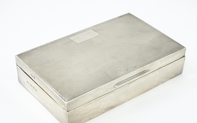 A silver table top cigarette box with engine turned decorati...