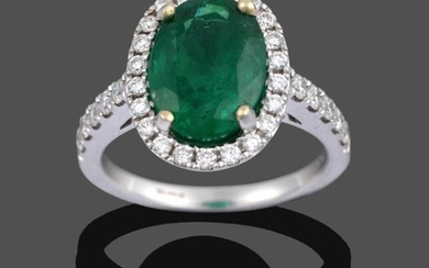 An 18 Carat Gold Emerald and Diamond Cluster Ring, the...