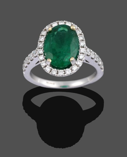 An 18 Carat Gold Emerald and Diamond Cluster Ring, the...