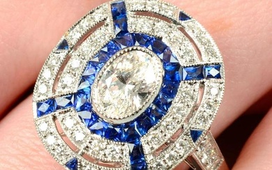 An 18ct gold diamond and calibre-cut sapphire dress ring.Principal diamond estimated weight 0.50ct