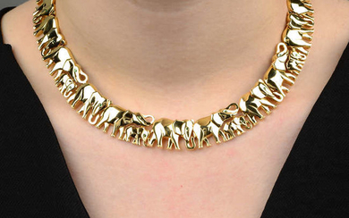 An 18ct gold emerald accent elephant collar, by Cartier.
