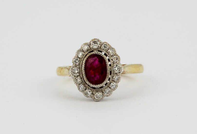 An 18ct yellow gold ruby and diamond set cluster ring, (N.5).