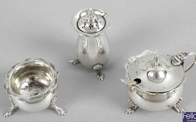 An Edwardian silver matched three piece condiment set, together with five silver napkin rings, a pair of sugar nips and a pierced slice.