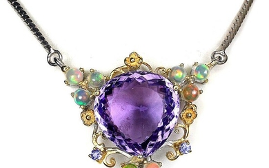 SOLD. An amethyst pendant set with a fancy-cut opal encircle by numerous opals and tanzanites, mounted in rhodium and gold plated sterling silver. L. 49 cm. – Bruun Rasmussen Auctioneers of Fine Art