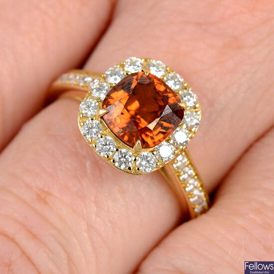 An orange zircon and brilliant-cut diamond cluster ring.