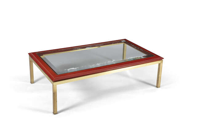 COFFEE TABLE A glass topped coffee table on...