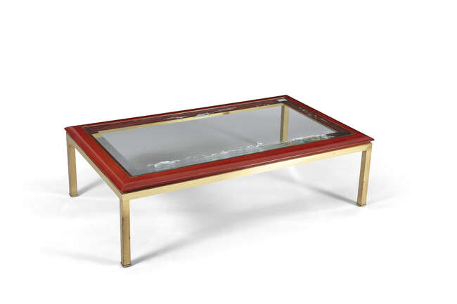 COFFEE TABLE A glass topped coffee table on...