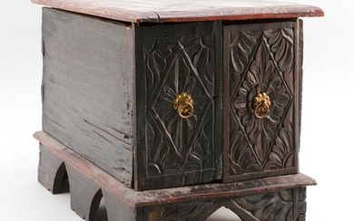 ASIAN CARVED AND PAINTED WOODEN CHEST Painted black, gold and red, and carved with foliate and geometric designs. Two doors at side...