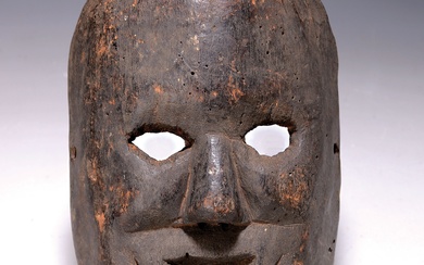 Face mask, Himalayan region, mid-20th century,carved wood, black-brown patina
