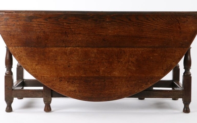 George I oak gate leg table, Welsh circa 1720, the oval drop leaf top with a single drawer to either