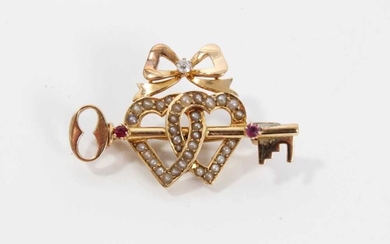 Late Victorian 15ct gold diamond, ruby and seed pearl sweetheart brooch with a gold key and two interlocking hearts surmounted by a bow. 36mm