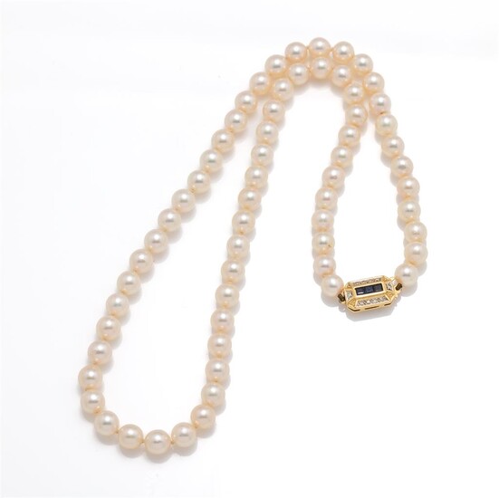 A long row of pearls with sapphire diamond clasp in...