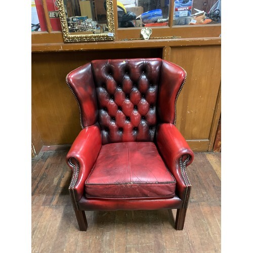 Oxblood leather wingback Chesterfield chair.
