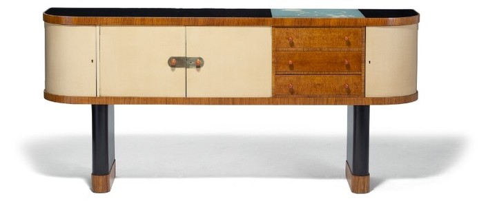 Torkov: A unique Zebrano sideboard on two black lacquered, oval pillar-legs. Black glass top and rounded front with three drawers and four doors.