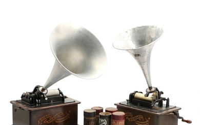 Two Edison Phonograph's in wooden cabinets and box with lacquer rolls. Early 20th century. H. 29. L. 33. W. 24 cm. (3)