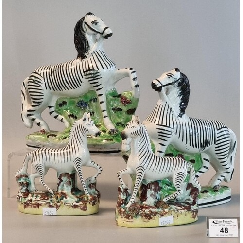 Two pairs of 19th Century Staffordshire pottery zebra, 22 an...