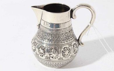 Victorian silver Indian Mughal style milk / cream jug embossed with nine signs of the Zodiac, each within a scrolled panel, (London 1877) maker Alexander Macrae, 3.5oz, 9cm in height