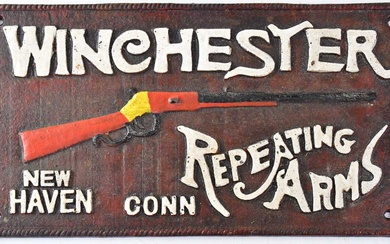 WINCHESTER REPEATING ARMS; a cast iron wall-hanging advertising plaque, stamped...