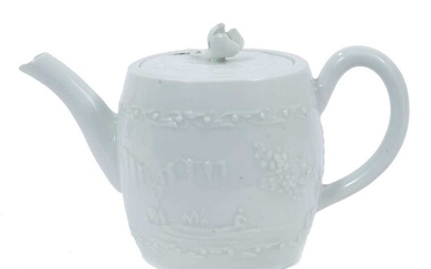 Worcester white-glazed teapot, circa 1760, of barrel form, decorated in relief with a Chinese fishing scene on one side, and flowers verso, 18cm from spout to handle