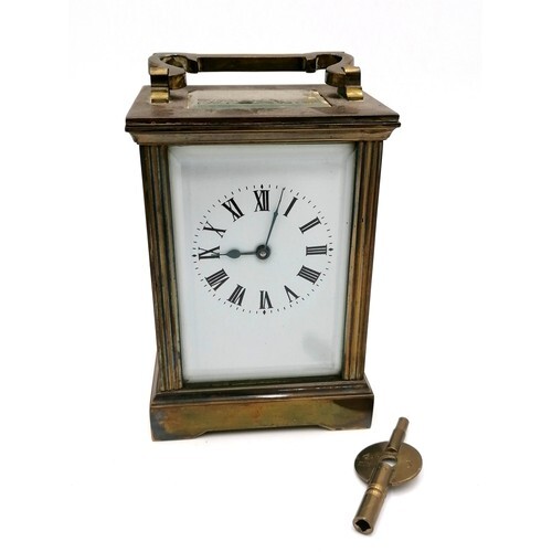 brass carriage clock with a porcelain face. Running, with ke...