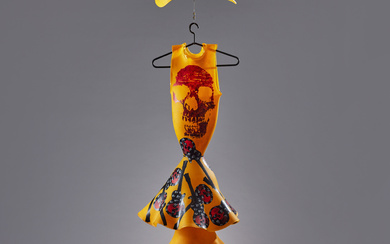 3416049. KJELL ENGMAN. Sculpture, Kosta Boda, unique, in the form of a hanging dress with a hat, five pieces, yellow glass mass with decoration in black, red and white of guitars and skulls.