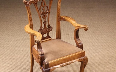 A 20th Century Chippendale Style Child's Armchair. The pierced back-splat carved with plumes of foli