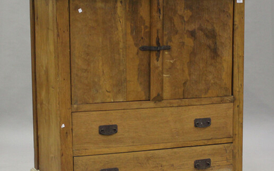 A 20th century hardwood cupboard, fitted with two doors and two drawers, the back with concealed com