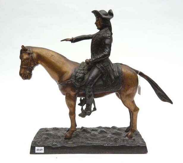 A BRONZE EQUESTRIAN FIGURE GROUP DEPICTING A MOUNTED SOLDIER, RAISED ON A NATURALISTICALLY MODELLED RECTANGULAR BASE, 50 CM WIDE, 42...
