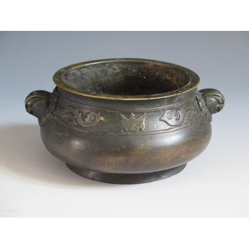 A Chinese Bronze Censer with bird and bat border and mask ha...