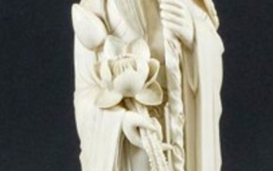 A Chinese Carved Ivory Standing Figure of a Sage...