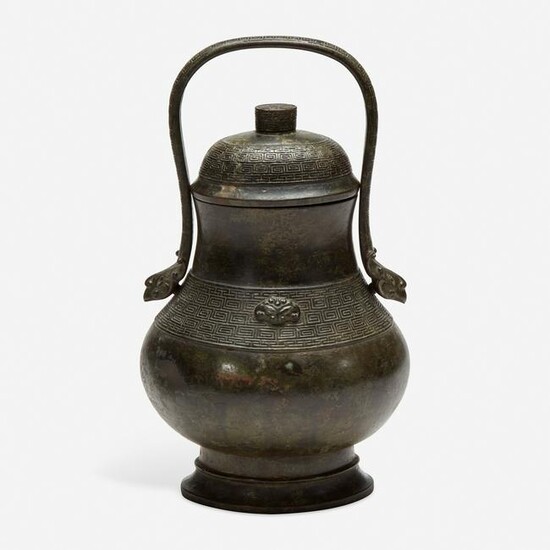A Chinese archaistic patinated bronze covered wine
