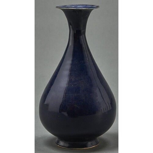A Chinese blue monochrome glazed vase, with flared neck and ...
