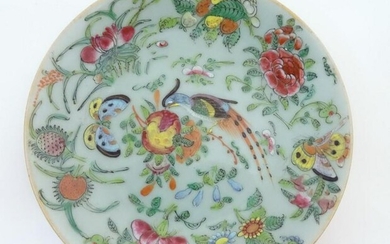 A Chinese celadon style plate decorated with bird