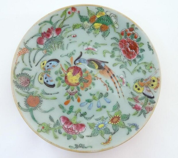 A Chinese celadon style plate decorated with bird
