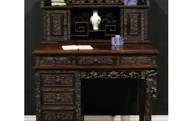 A Chinese export hardwood desk, inverted break-centre supers...