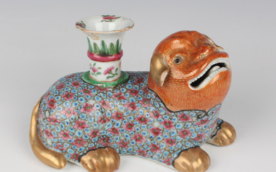 A Chinese famille rose porcelain jostick holder, mid-19th century, modelled as a recumbent puppy, th