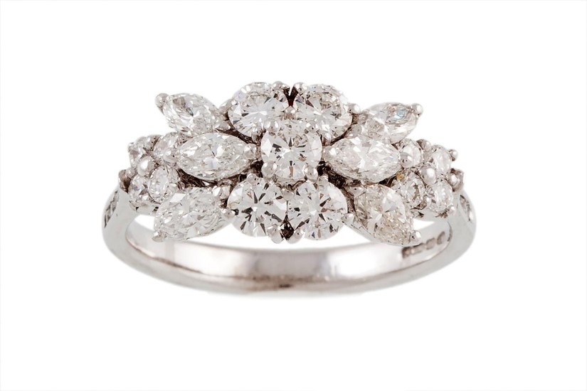 A DIAMOND CLUSTER RING, with oval and brilliant cut diamonds...