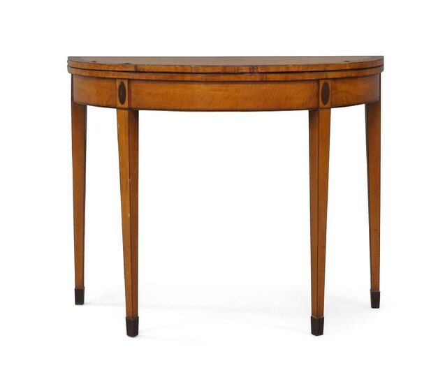 A George III satinwood fold over tea table, mahogany crossbanding, raised on square tapered legs to castors, 74cm high, 93cm wide, 44cm deep
