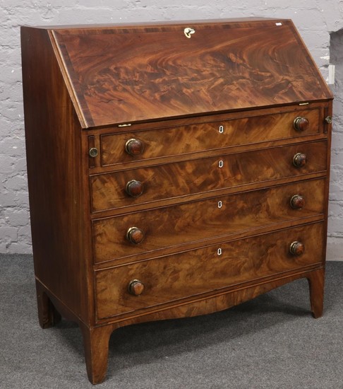 A Georgian flame mahogany bureau with fitted interior over f...