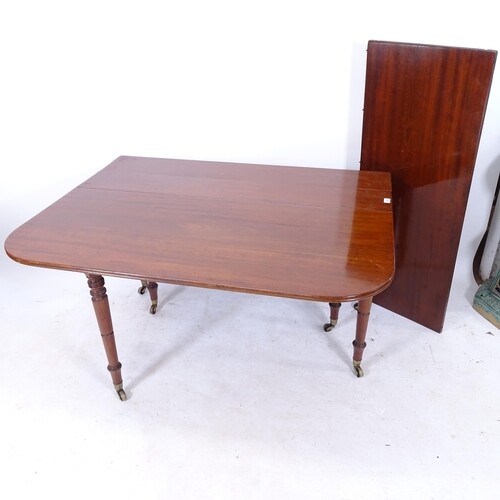 A Georgian mahogany drop leaf extending dining table, with r...