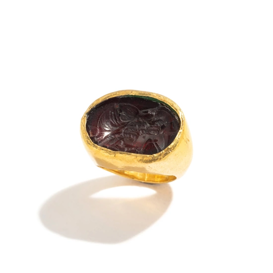 A Greek Gold and Garnet Finger Ring with the Goddess Isis