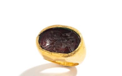 A Greek Gold and Garnet Finger Ring with the Goddess Isis