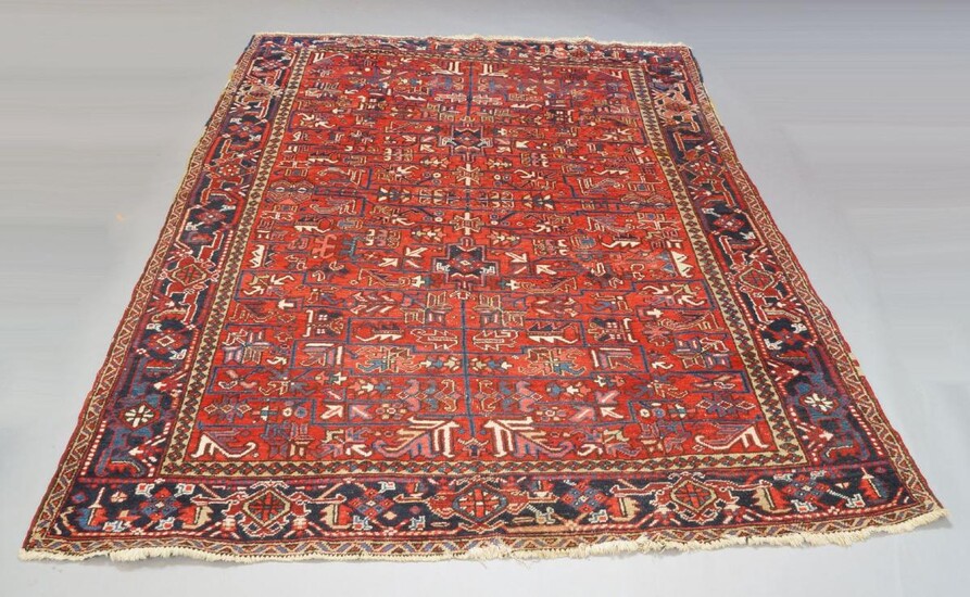A Hamedan carpet with all-over design in red field, deep blue border, early to mid 20th century, 310cm by 244cm