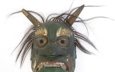 A Japanese carved Midori Oni mask with hair and traces