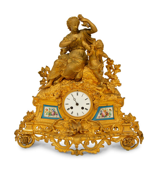 A Louis XV Style Gilt Bronze and Porcelain Inset Mantel Clock