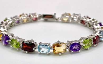 A Multi-Gemstone Bracelet consisting of: Peridots, Amethysts, Blue topaz,...